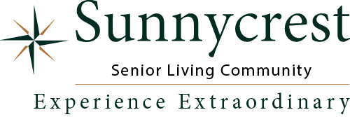 Logo of Sunnycrest Senior Living Community. Features a compass star on the left and text that reads "Sunnycrest Senior Living Community" with the tagline "Experience Extraordinary" below.