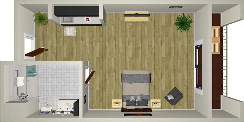 A top-down view of a compact, modern studio apartment. The layout features a combination living/sleeping area with a bed, a chair, a TV, and two side tables. There's a small kitchen with minimal counter space and a separate bathroom with a shower, toilet, and sink.
