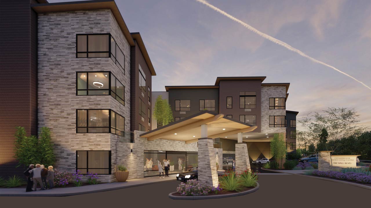 A modern, multi-story hotel with large windows and stone accents is seen at dusk. Guests stand near the entrance under a wooden canopy, while a car waits at the covered drop-off area.